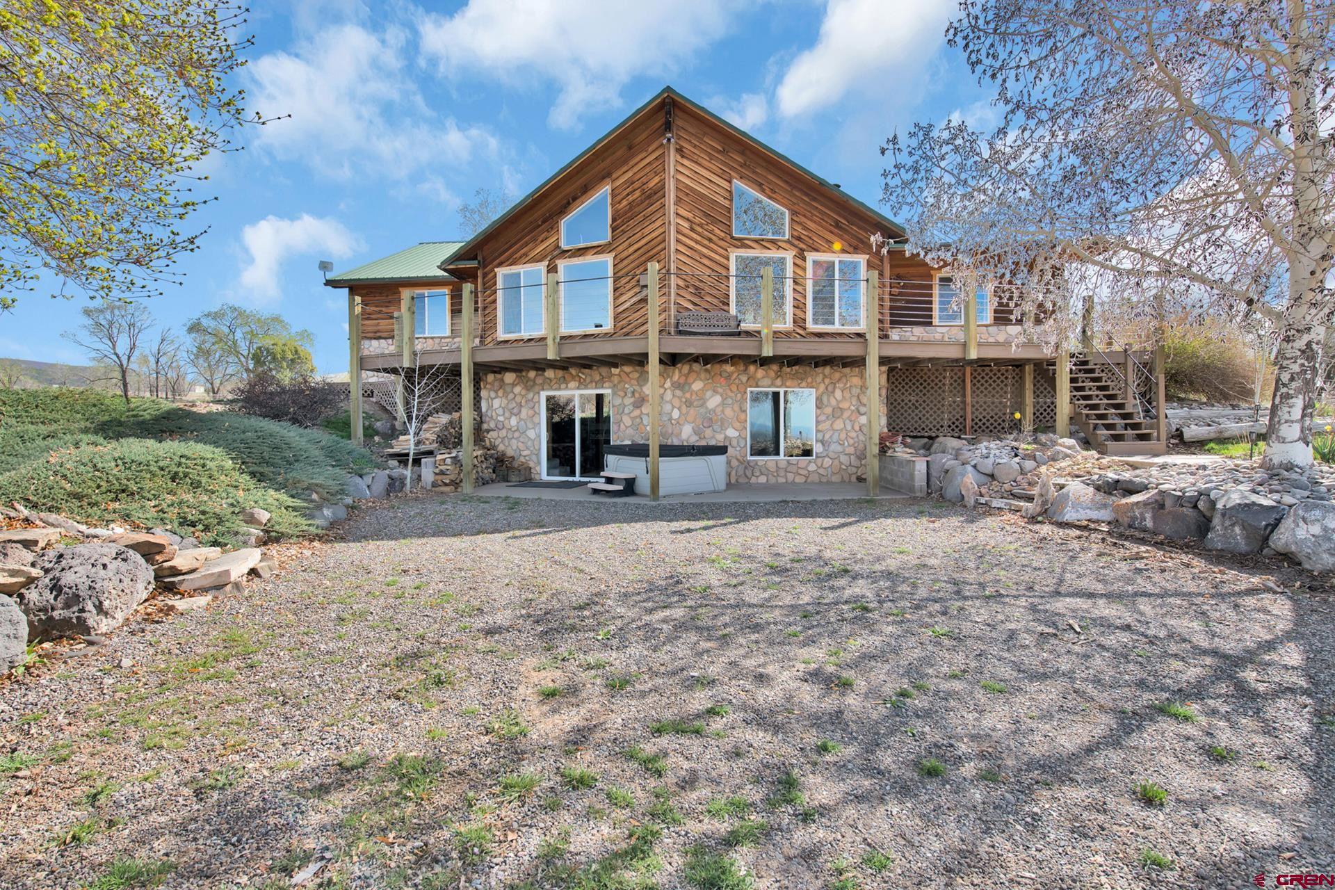 19122 2325th Road Cedaredge, CO 81413 - Photo 4 of 45 a front view of a house with yard and green space