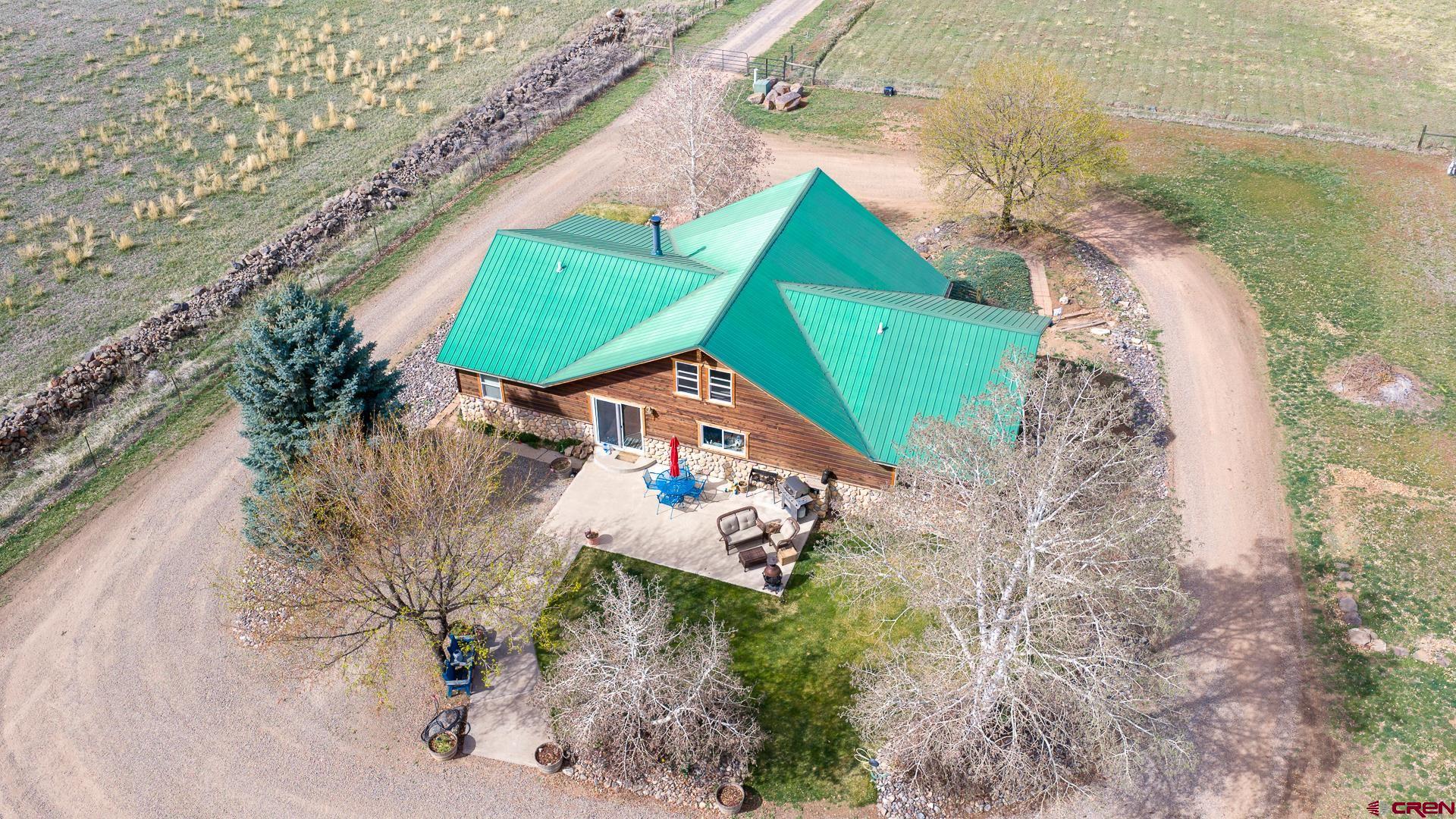 19122 2325th Road Cedaredge, CO 81413 - Photo 44 of 45 an aerial view of a house with a yard and lake view