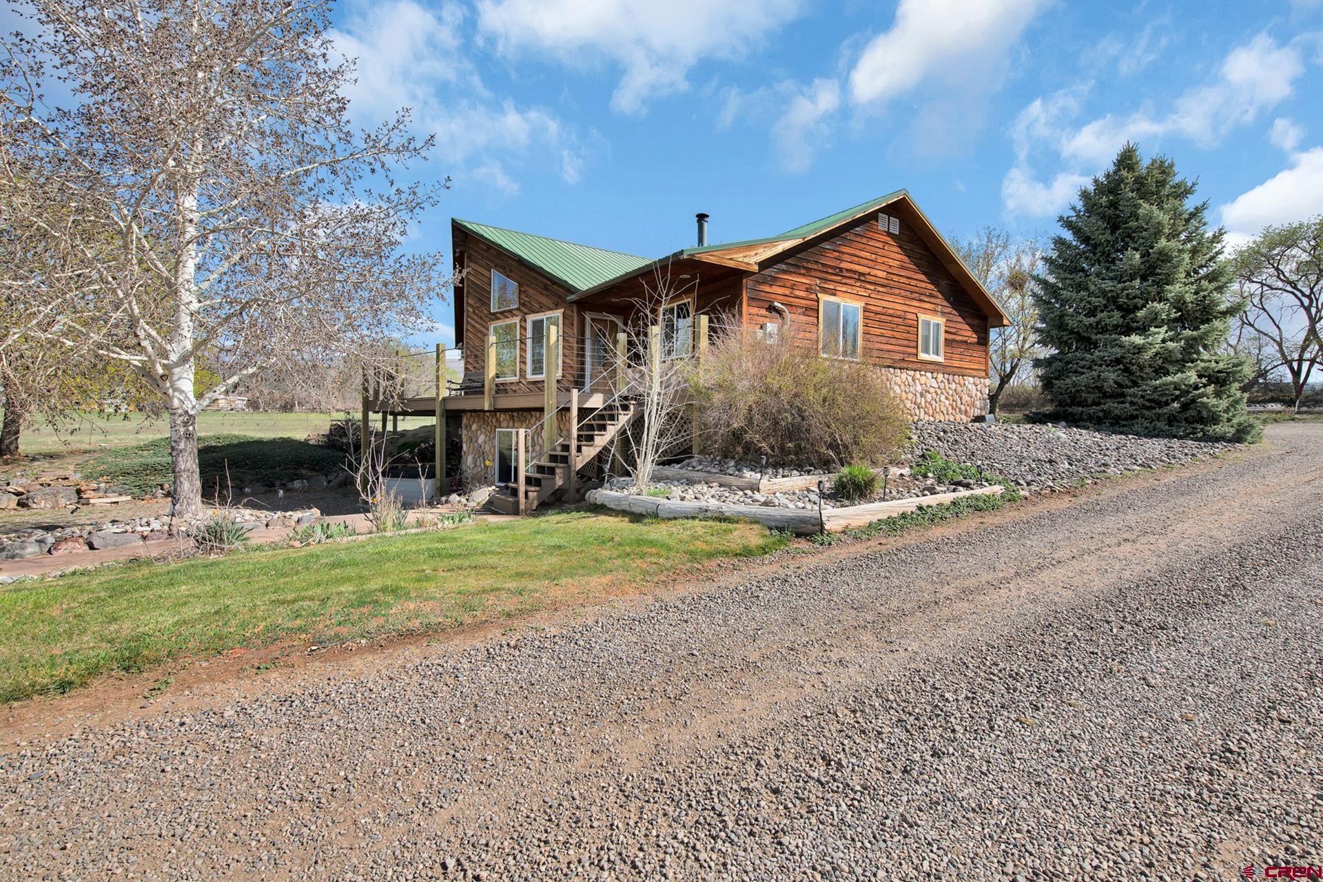19122 2325th Road Cedaredge, CO 81413 - Photo 5 of 45 a front view of a house with a yard