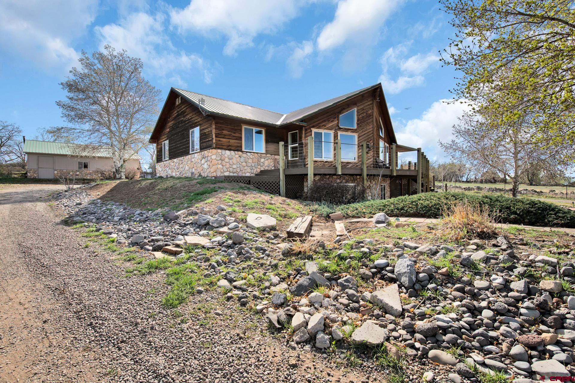 19122 2325th Road Cedaredge, CO 81413 - Photo 6 of 45 a front view of a house with a yard