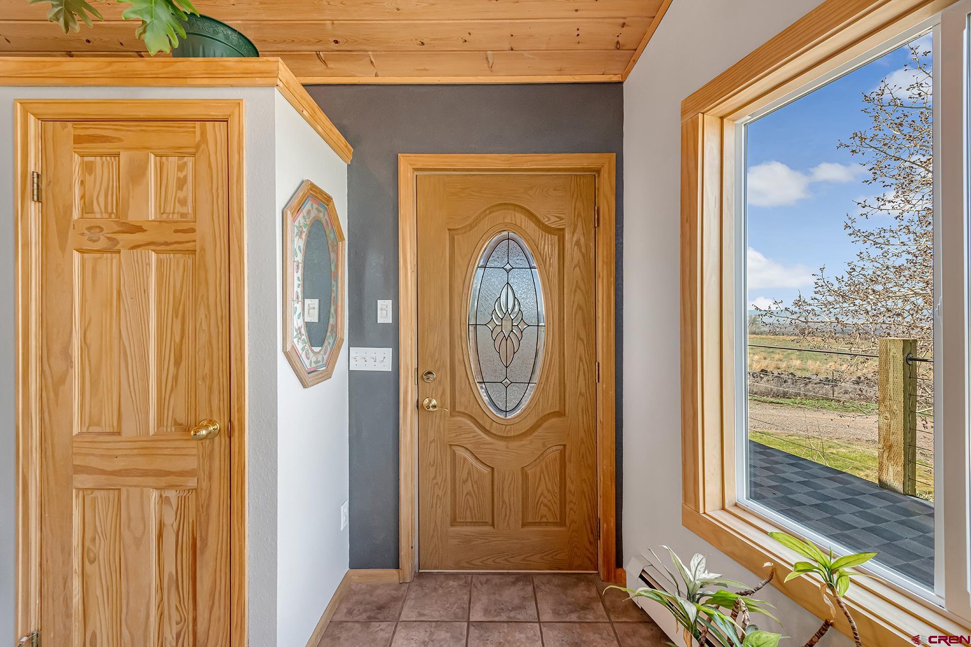 19122 2325th Road Cedaredge, CO 81413 - Photo 8 of 45 a front view of a door with wooden walls