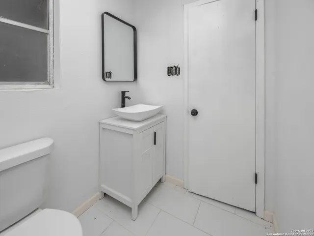 a bathroom with a sink toilet and vanity