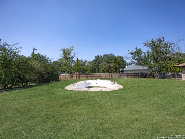 a view of a swimming pool with a yard