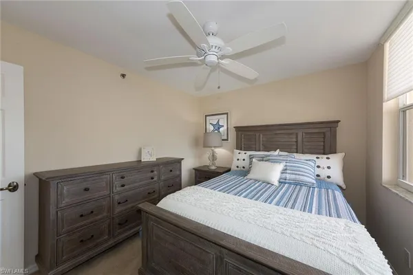 a bedroom with a large bed and a window