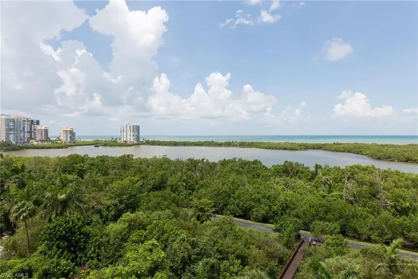 a view of a lake and green valley