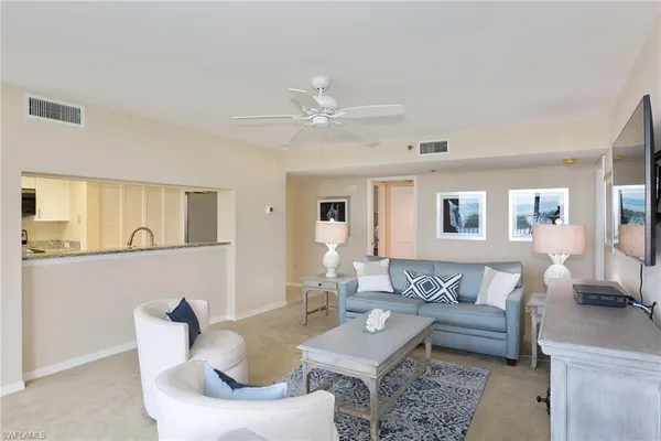 a living room with furniture and white walls