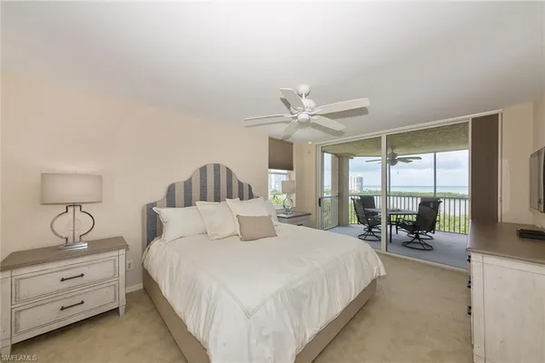 a bedroom with a bed and large mirror