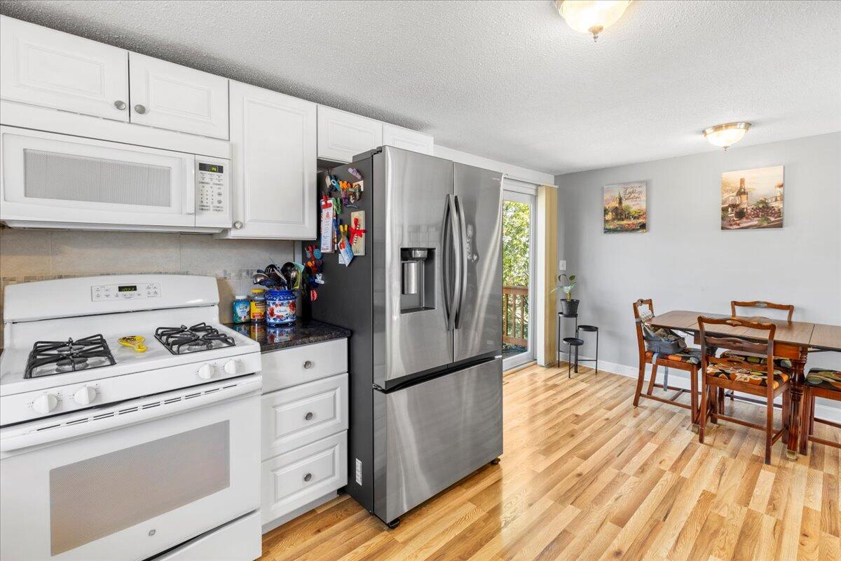 66 Barker Road Wareham, MA 02538 - Photo 12 of 18 a kitchen with white cabinets and stainless steel appliances