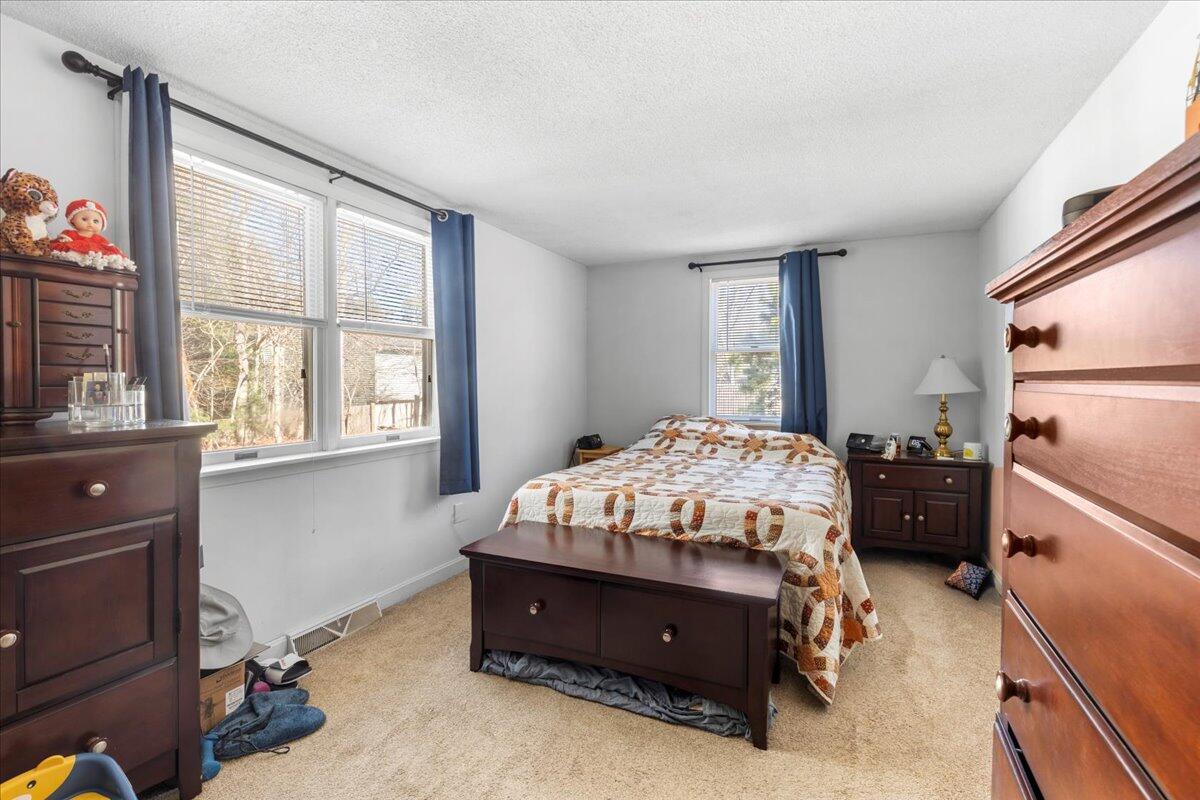 66 Barker Road Wareham, MA 02538 - Photo 14 of 18 a bed sitting in a bedroom next to a window