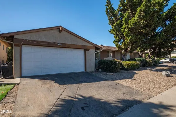 a view of a street with a house in the background