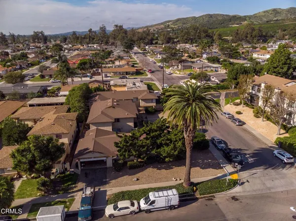 a view of a backyard with plants and lake view