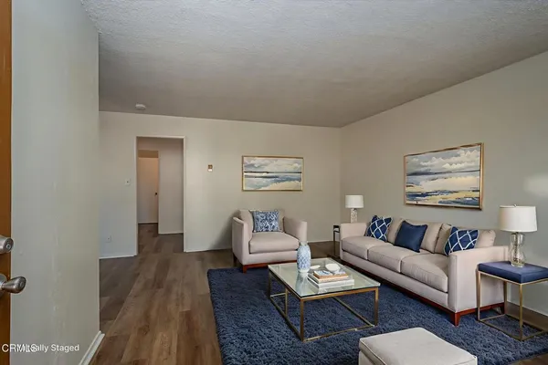 a view of a room with wooden floor