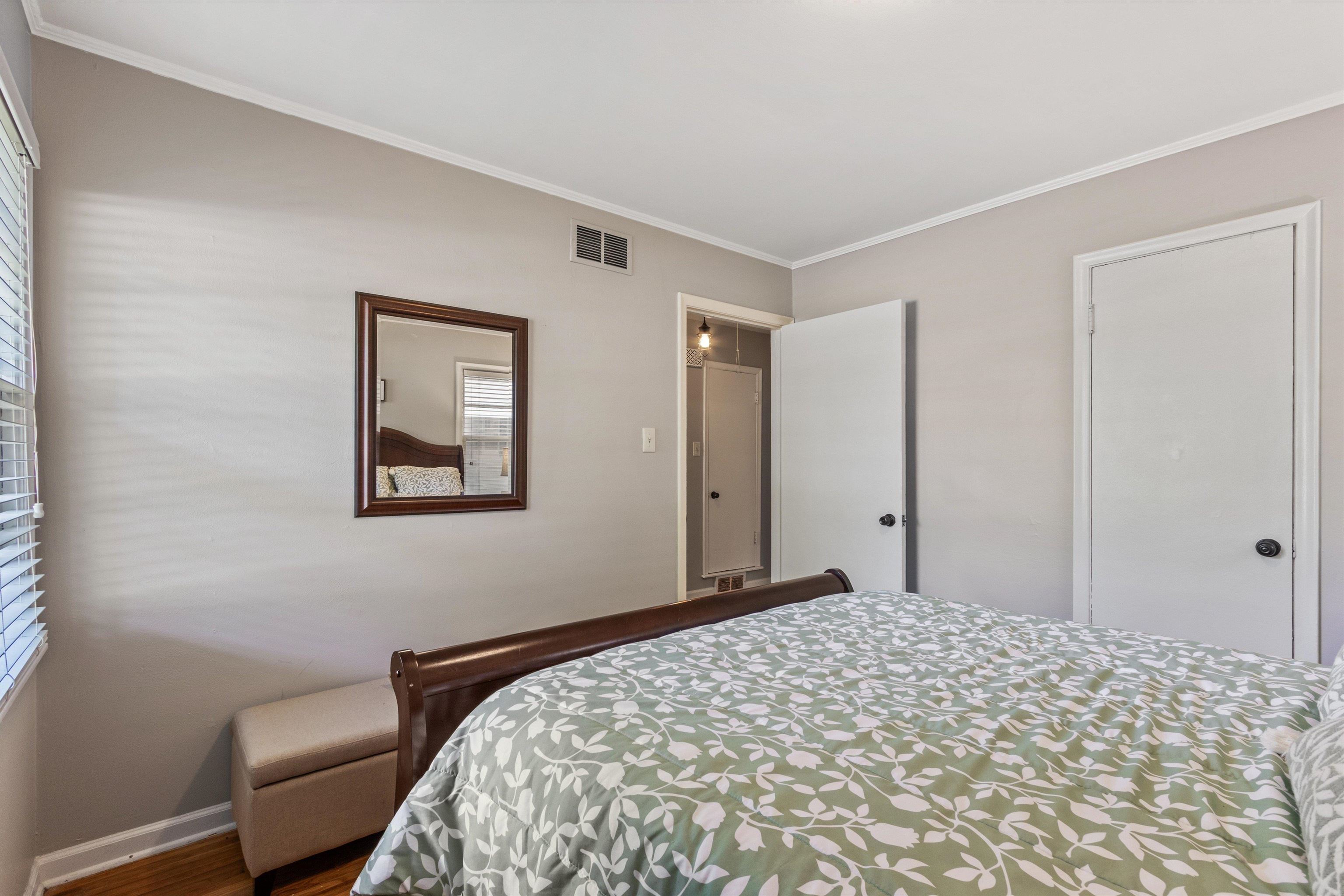 4951 Flamingo Road Memphis, TN 38117 - Photo 12 of 27 Light-toned walls with contrasting white trim, wood-finish flooring, and a window with blinds