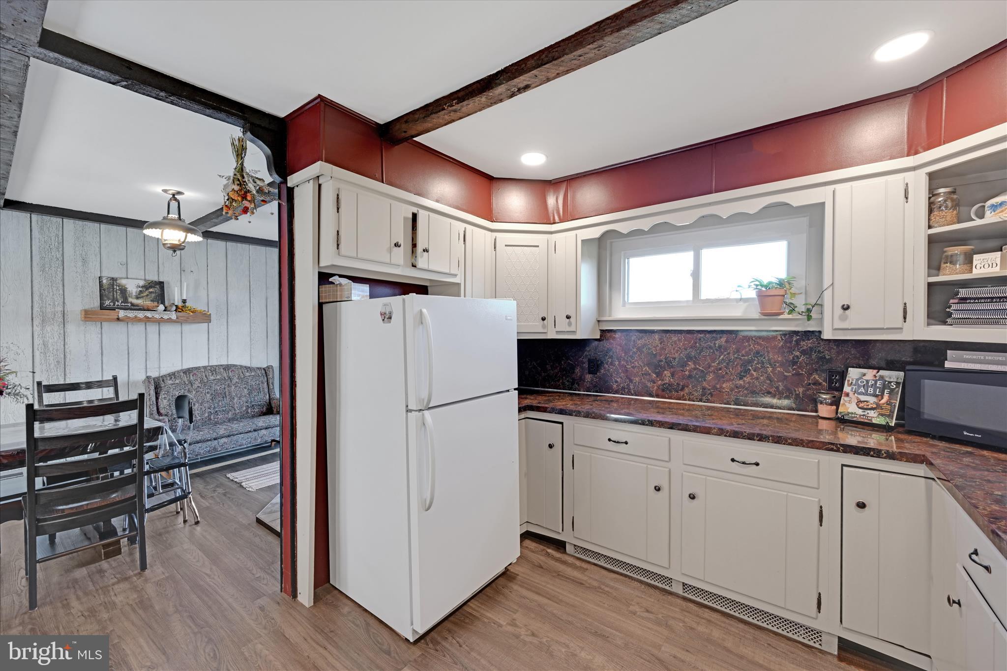 175 Strack Drive Myerstown, PA 17067 - Photo 24 of 52 a kitchen with granite countertop a refrigerator a sink and white cabinets