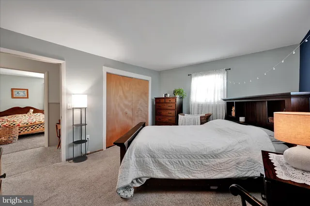 a bedroom with a bed and a large mirror