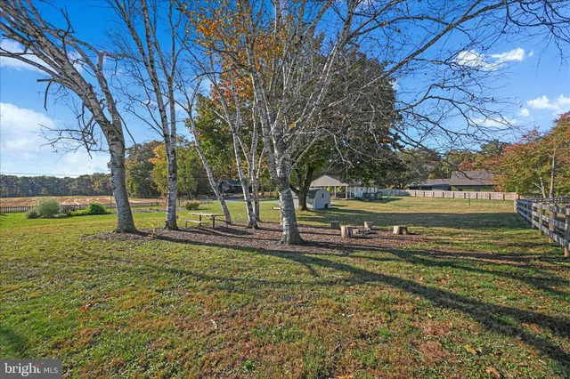 a view of a house with a yard and garden