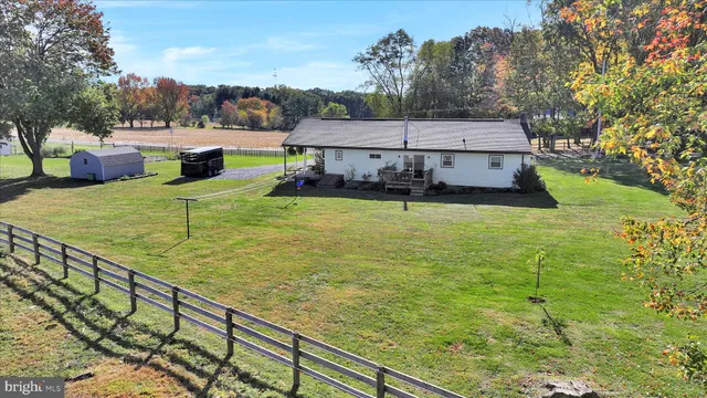 a aerial view of a house with a yard table and chairs