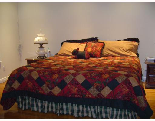 610 Elm Street Portland, TX 78374 - Photo 9 of 10 a bedroom with a bed and a lamp