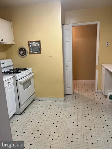 a kitchen with a stove a sink and a refrigerator