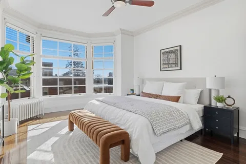 a bedroom with a large bed and a window