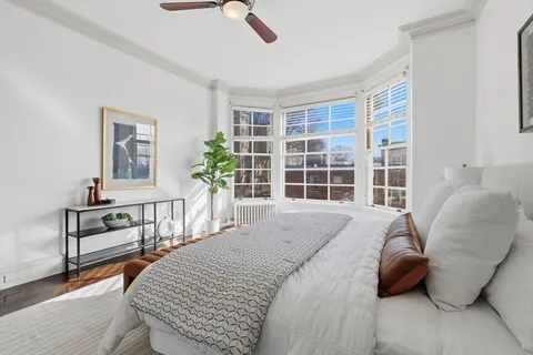 a bedroom with a bed next to a window with outer view