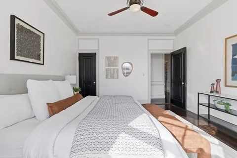a bedroom with a bed and a chandelier