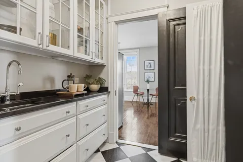 a kitchen with a refrigerator and cabinets