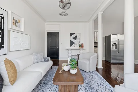 a living room with furniture and a rug