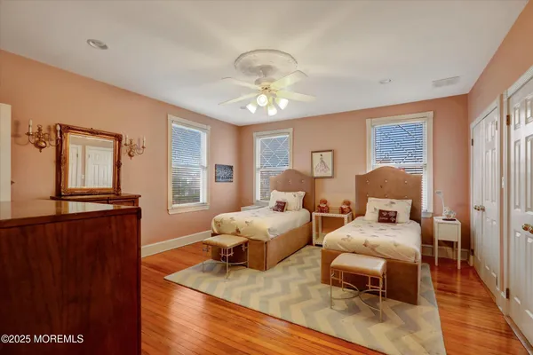 a bedroom with furniture and wooden floor