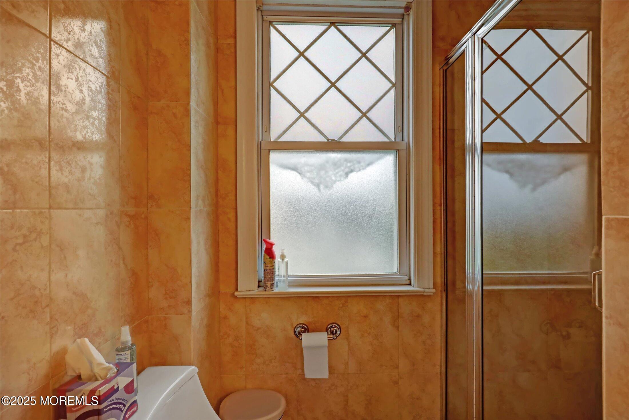48 Neptune Avenue Deal, NJ 07723 - Photo 11 of 64 a bathroom with a window and a shower