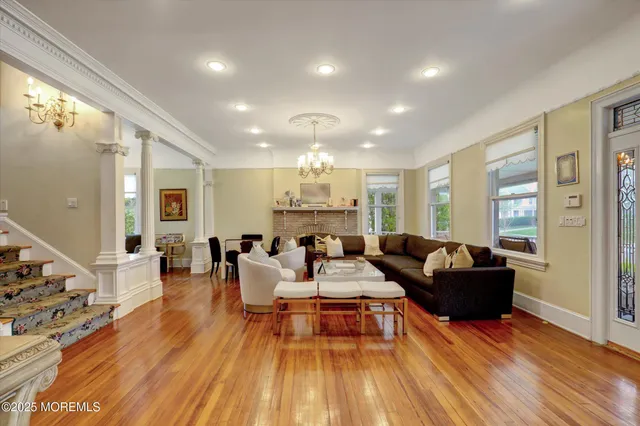a view of a dining room with furniture wooden floor and chandelier