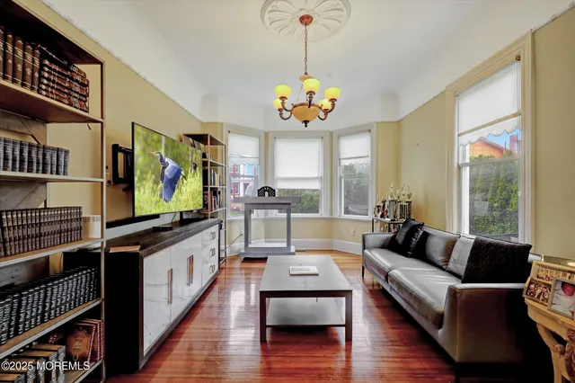 a view of a dining room with furniture wooden floor and chandelier