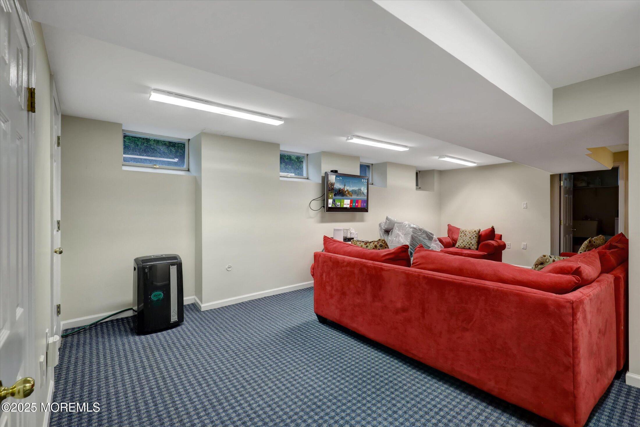 48 Neptune Avenue Deal, NJ 07723 - Photo 15 of 64 a living room with furniture and a flat screen tv