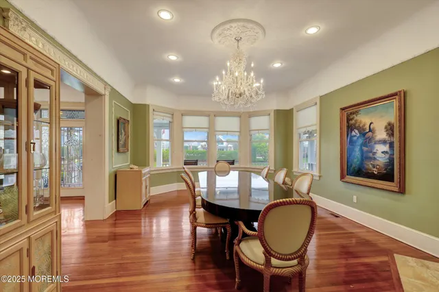 a large kitchen with stainless steel appliances kitchen island granite countertop a stove a sink a refrigerator and a wooden cabinets