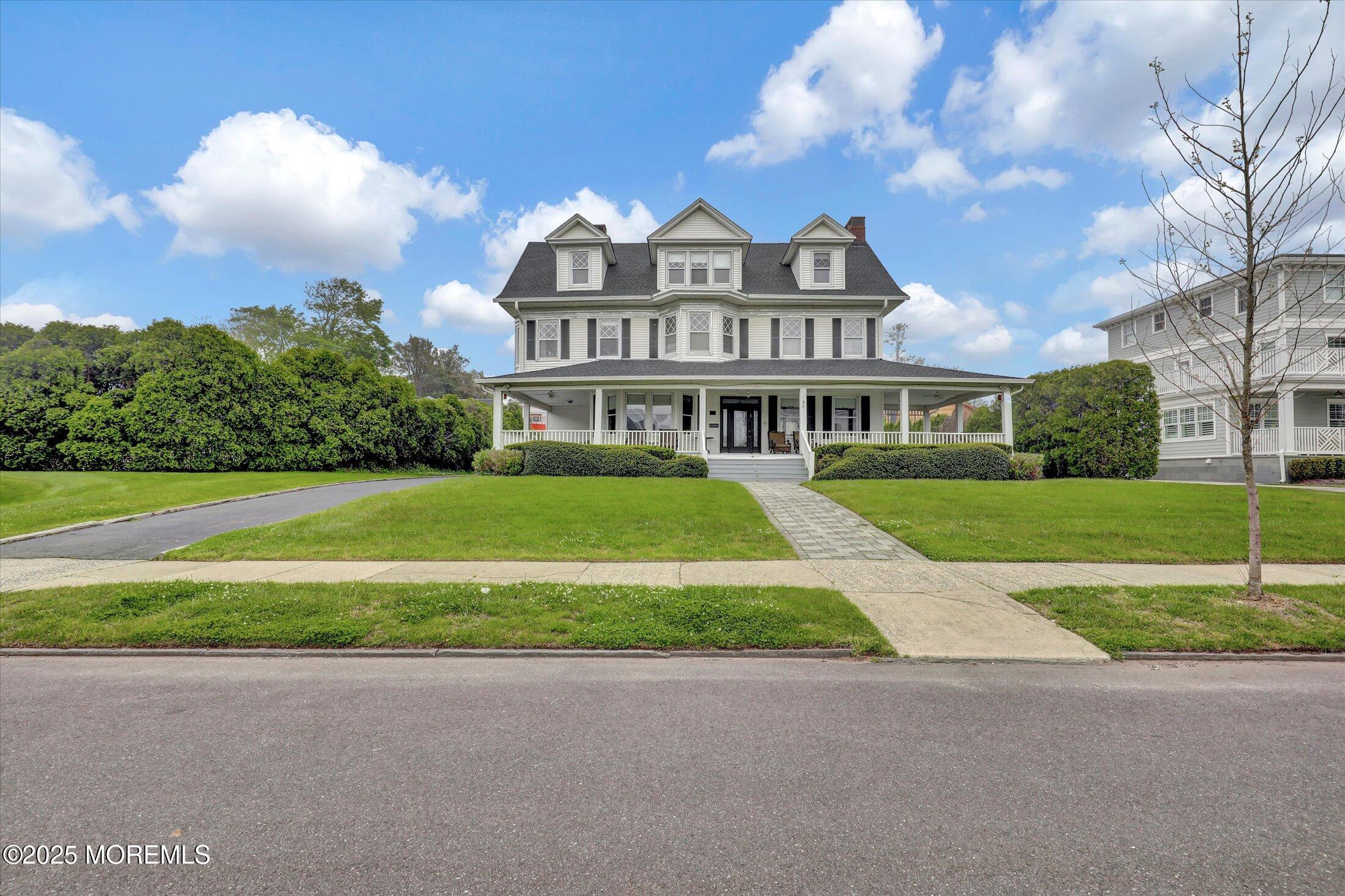 48 Neptune Avenue Deal, NJ 07723 - Photo 20 of 64 a view of a big house with a big yard and large trees