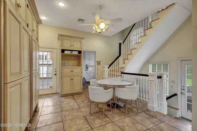 a spacious bedroom with a bed a couch and dresser