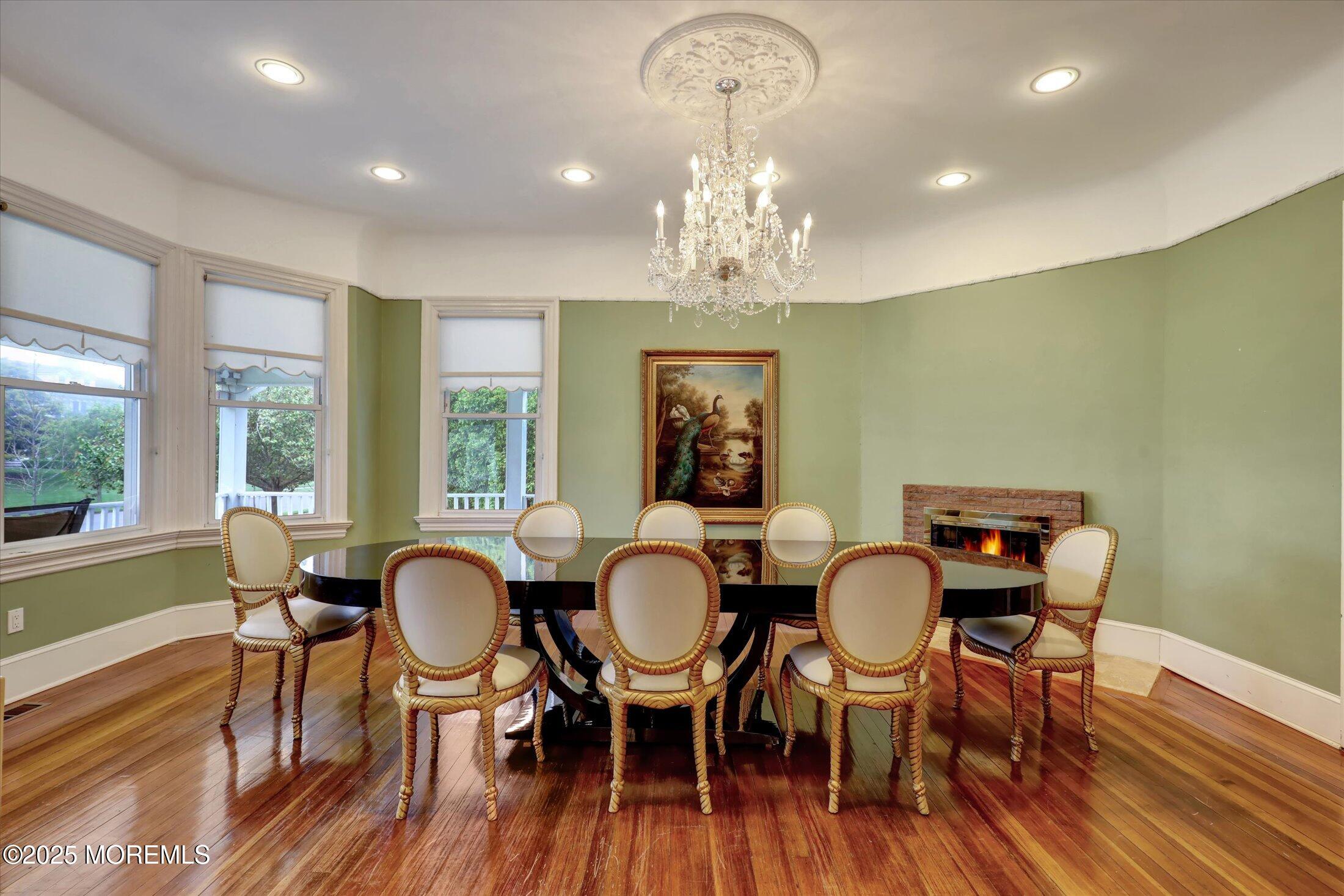 48 Neptune Avenue Deal, NJ 07723 - Photo 31 of 64 a view of a dining room with furniture wooden floor and chandelier