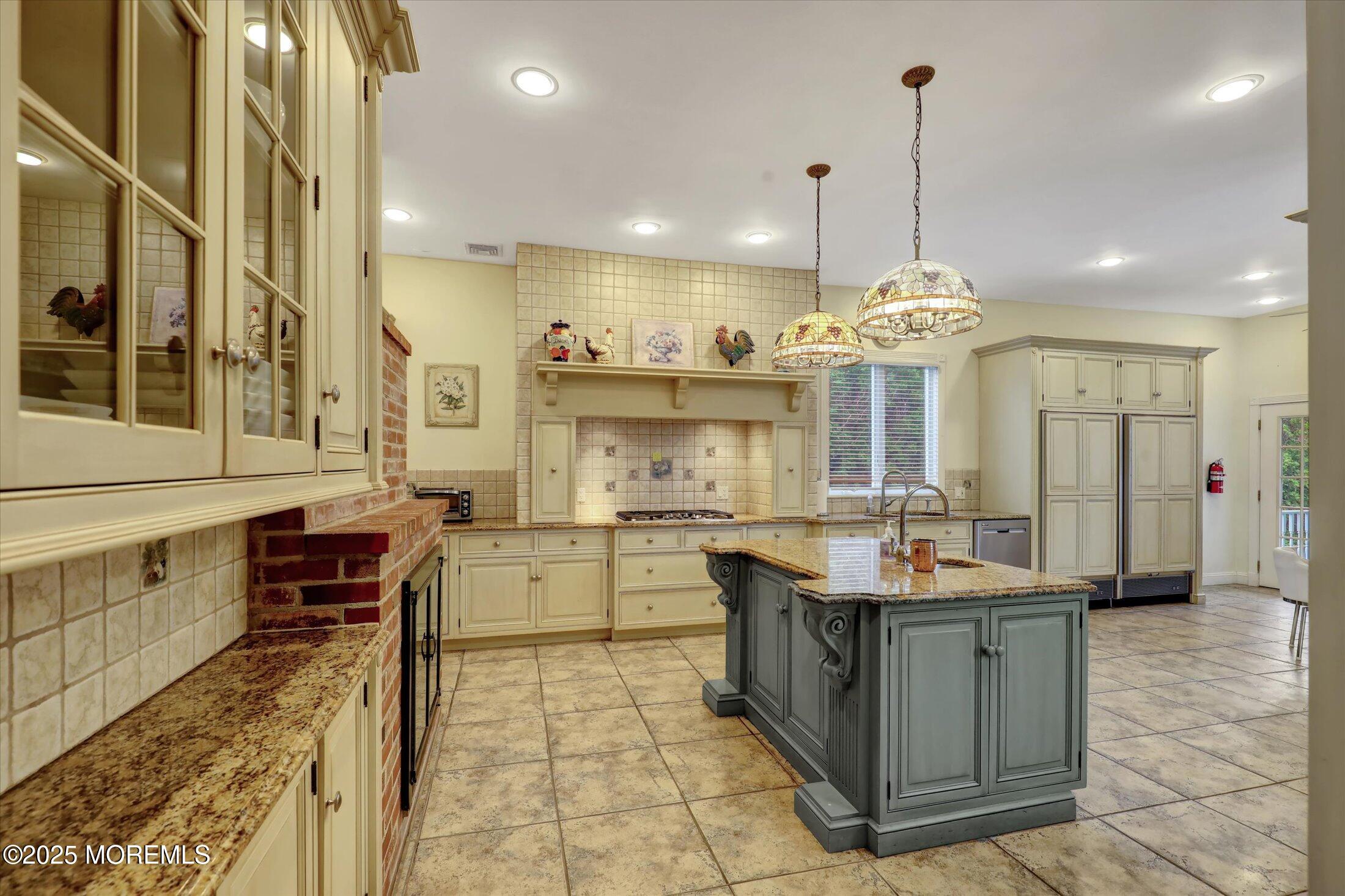 48 Neptune Avenue Deal, NJ 07723 - Photo 33 of 64 a large kitchen with a counter space a sink stainless steel appliances and cabinets