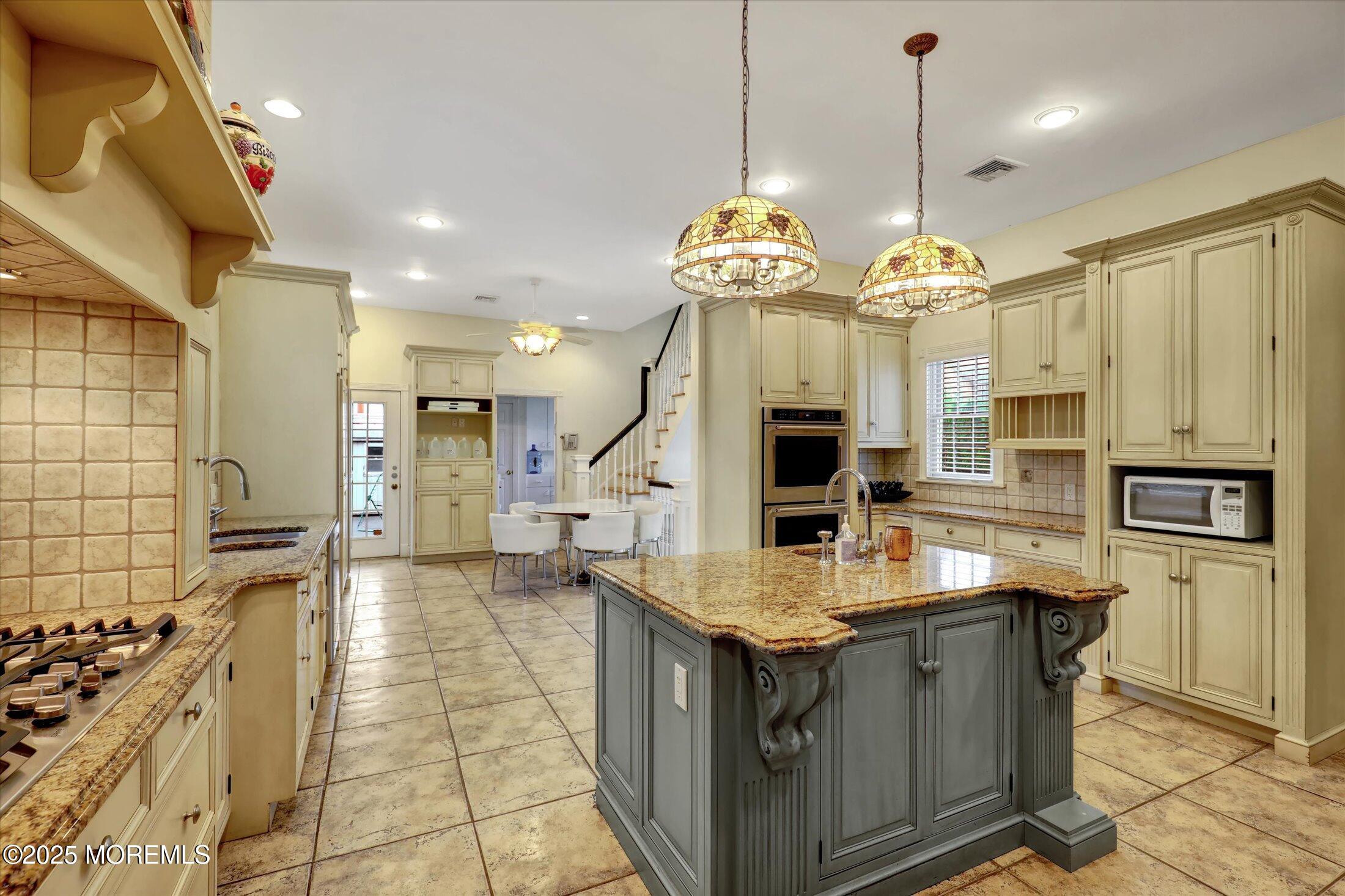 48 Neptune Avenue Deal, NJ 07723 - Photo 36 of 64 a kitchen with stainless steel appliances granite countertop a stove and refrigerator