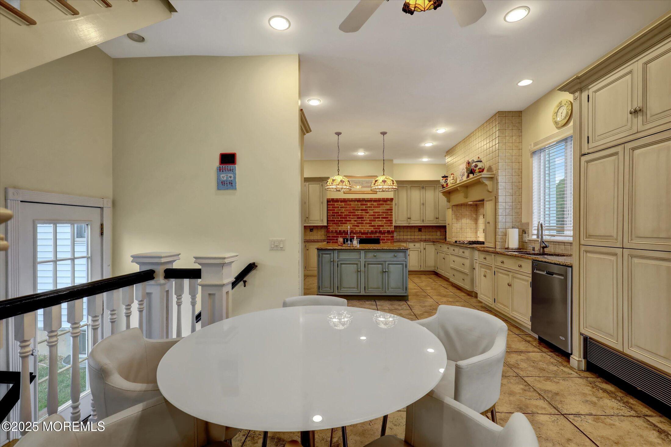 48 Neptune Avenue Deal, NJ 07723 - Photo 40 of 64 a kitchen with sink a refrigerator and chairs
