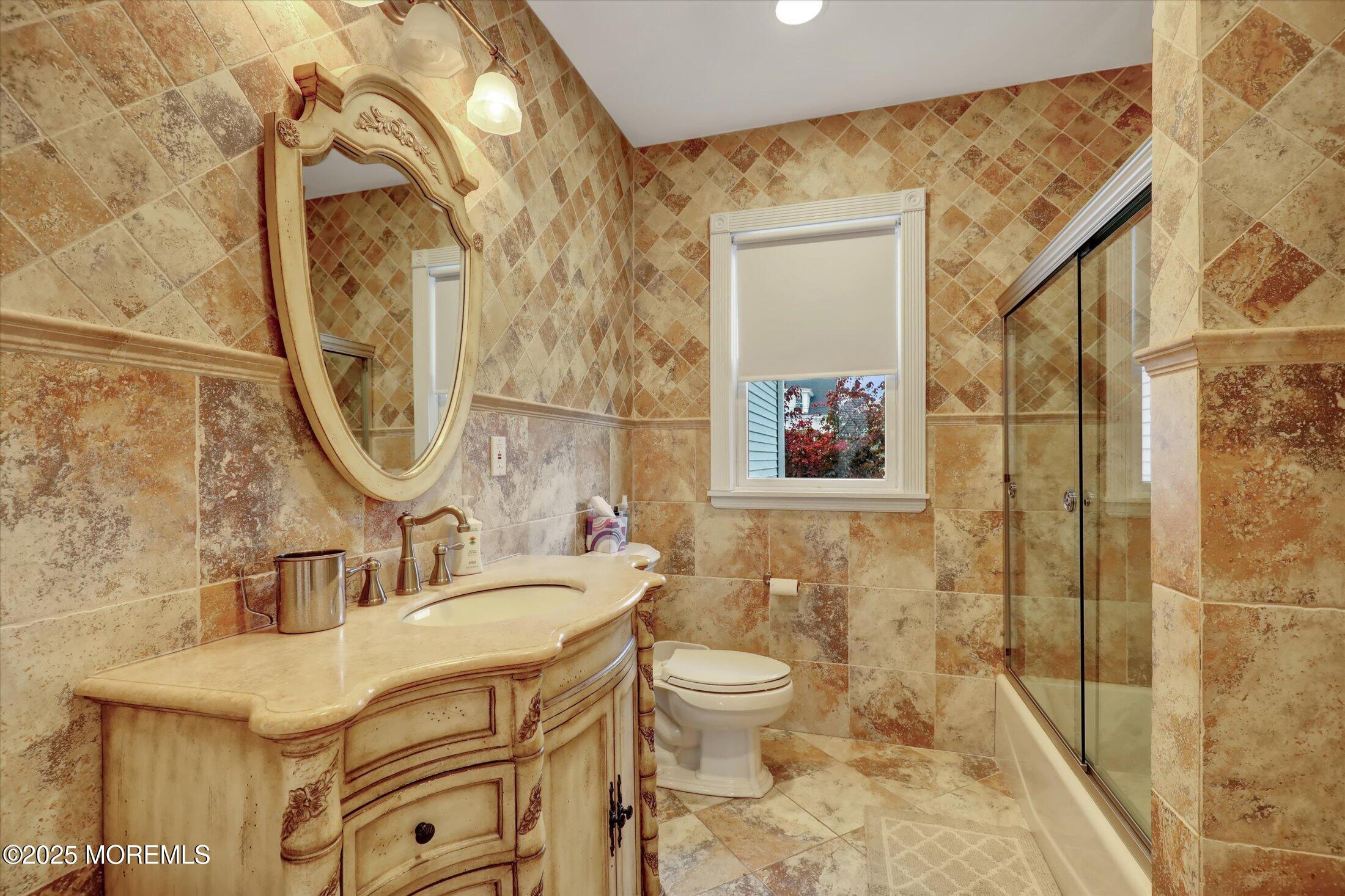 48 Neptune Avenue Deal, NJ 07723 - Photo 4 of 64 a bathroom with a sink a toilet and shower