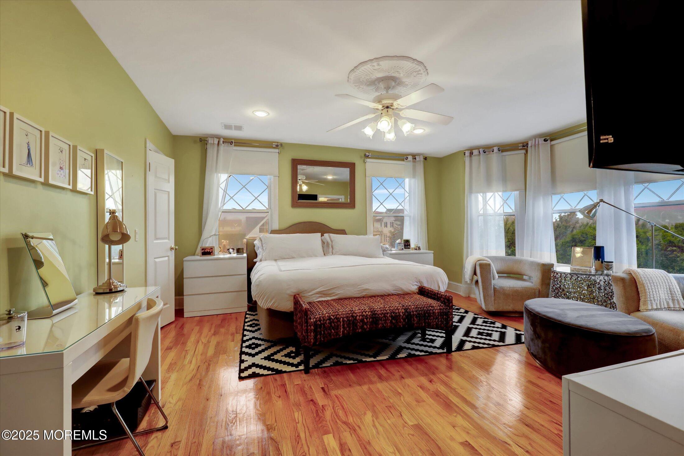 48 Neptune Avenue Deal, NJ 07723 - Photo 43 of 64 a spacious bedroom with a bed a couch and dresser