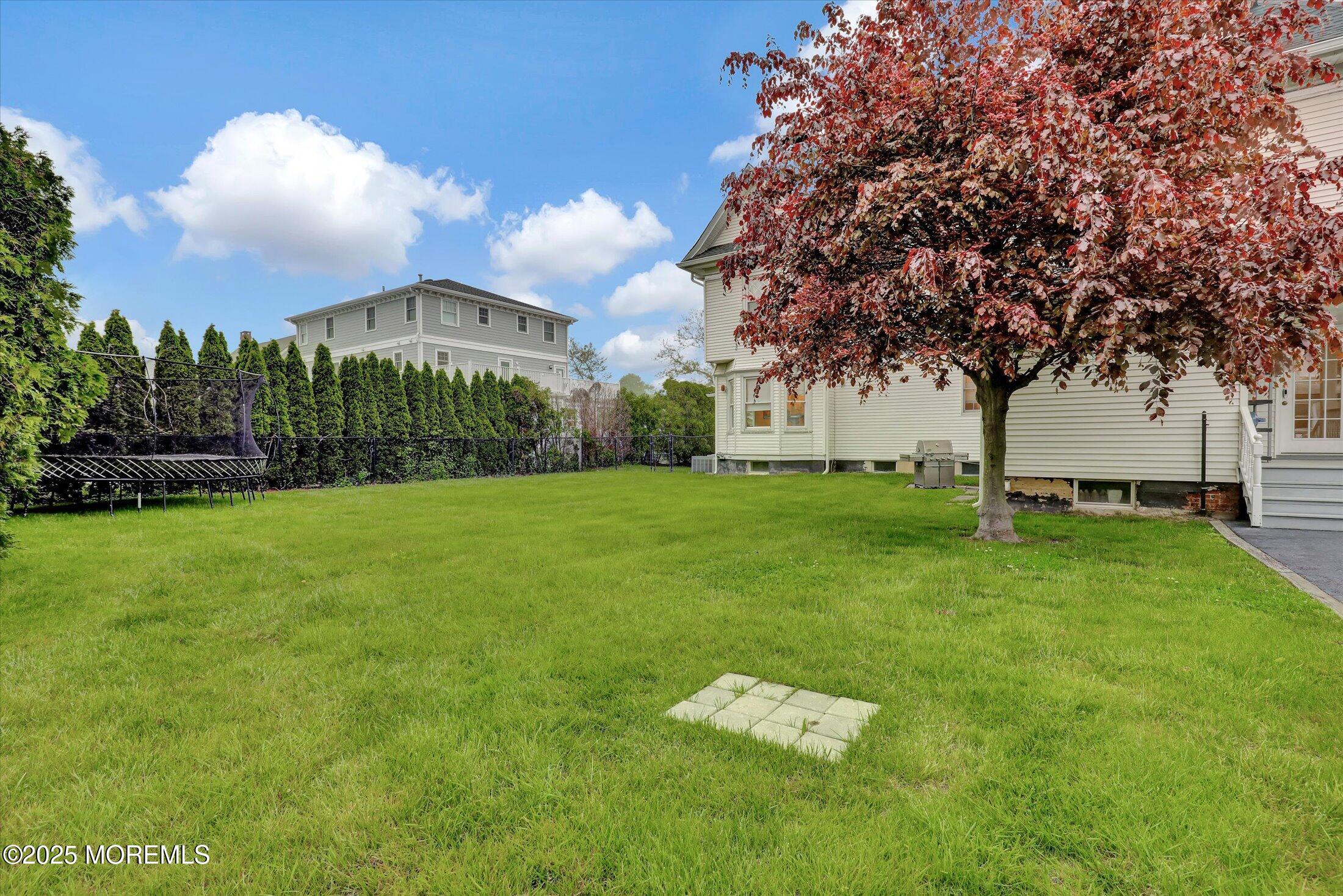 48 Neptune Avenue Deal, NJ 07723 - Photo 47 of 64 a view of a fountain in front of a house with a big yard