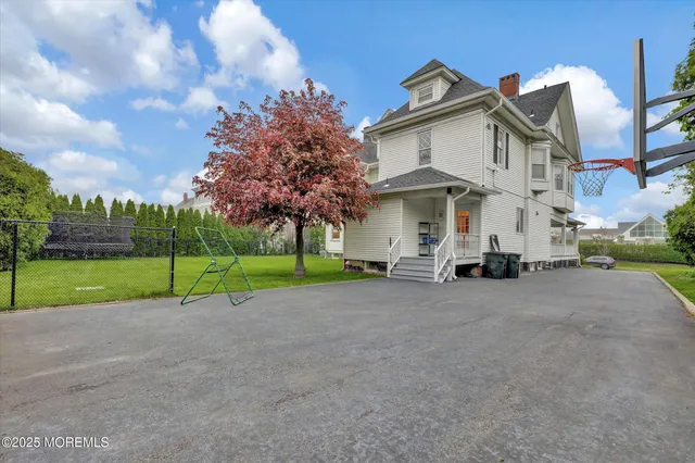 an aerial view of a house with garden space and street view