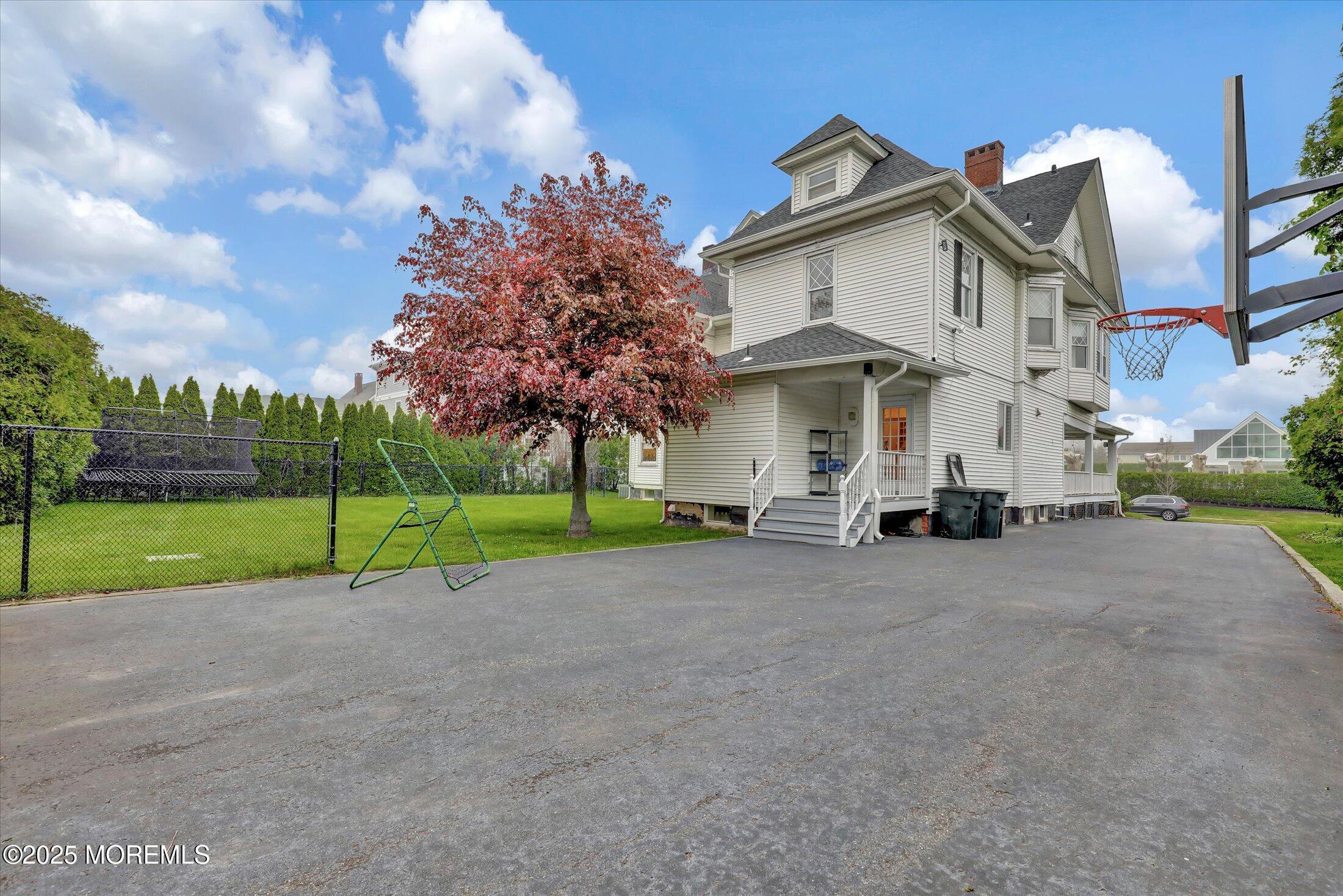 48 Neptune Avenue Deal, NJ 07723 - Photo 50 of 64 a view of a house with a big yard and large trees