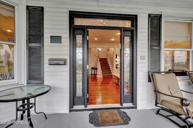 a living room with fireplace furniture and a wooden floor