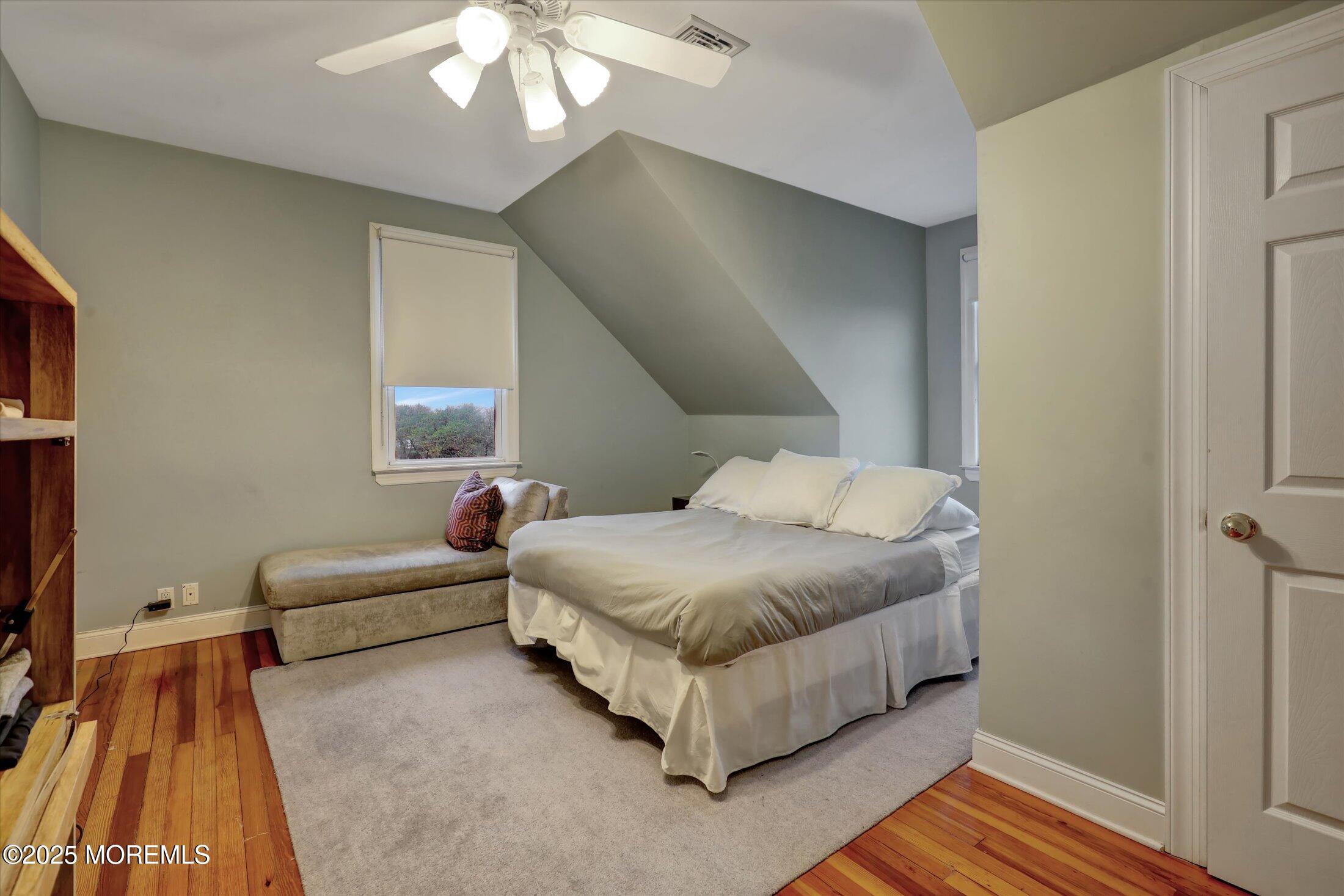 48 Neptune Avenue Deal, NJ 07723 - Photo 9 of 64 a spacious bedroom with a bed and a couch