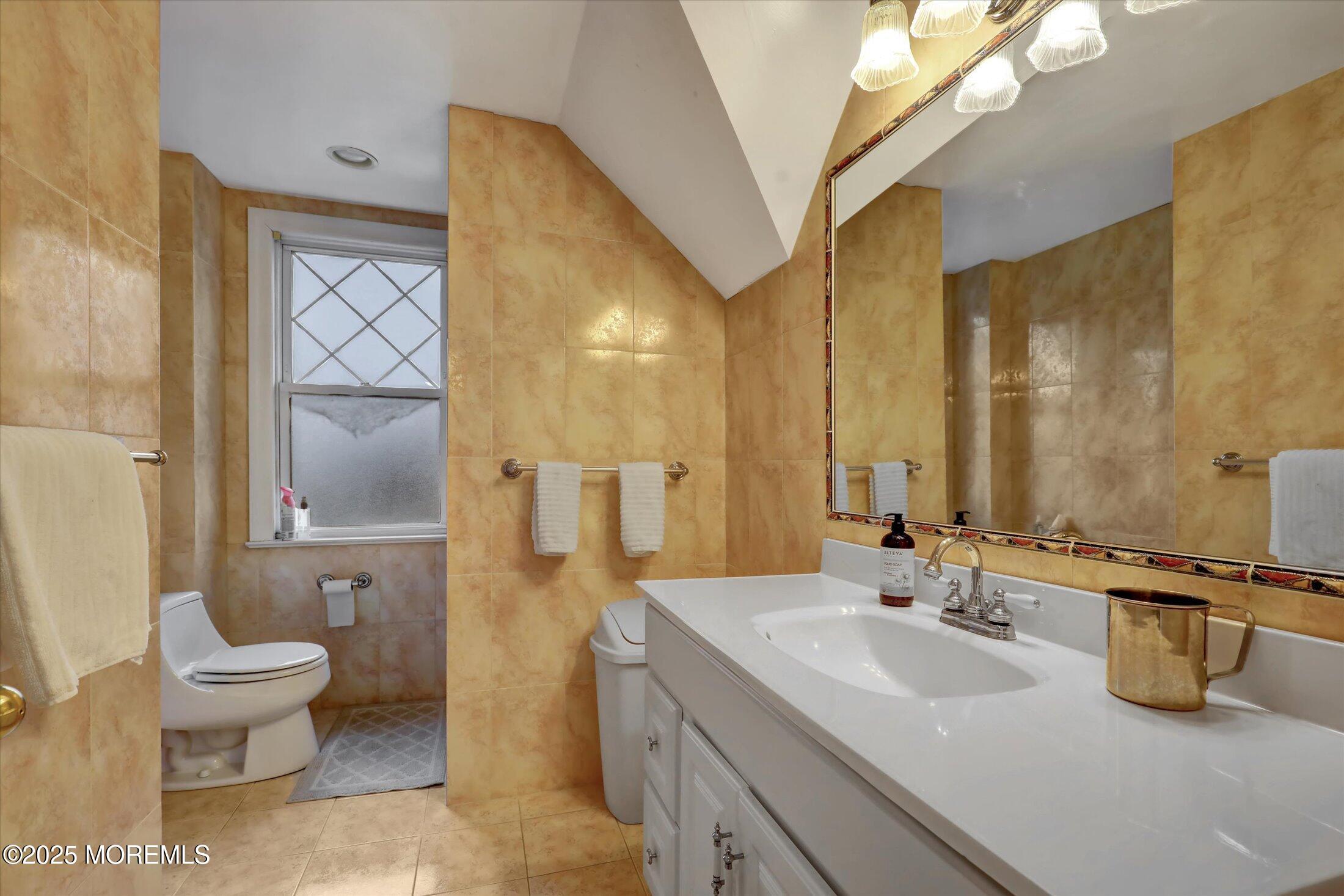 48 Neptune Avenue Deal, NJ 07723 - Photo 10 of 64 a bathroom with a sink and a mirror