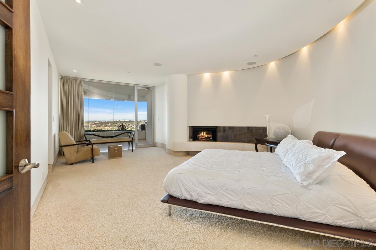 7455 Hillside Drive La Jolla, CA 92037 - Photo 21 of 33 a bedroom with a bed and a flat screen tv