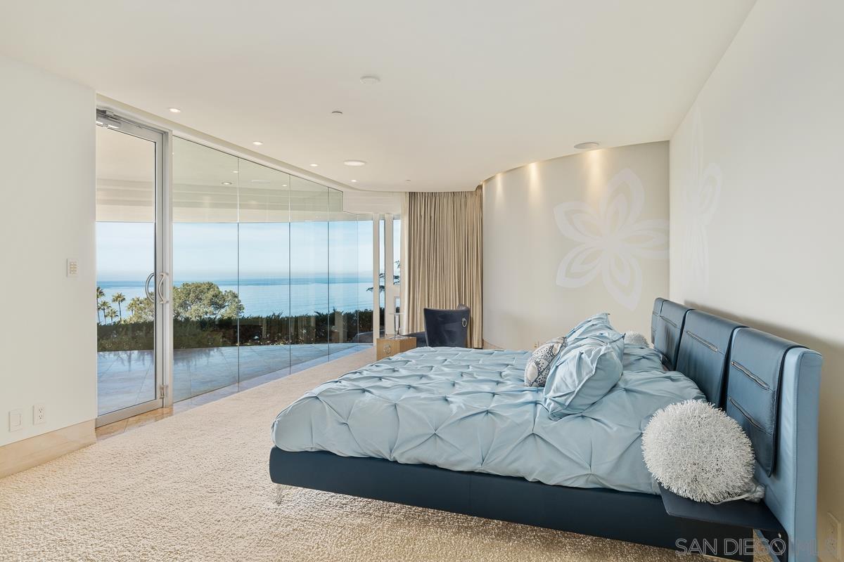 7455 Hillside Drive La Jolla, CA 92037 - Photo 24 of 33 a spacious bedroom with a bed and window